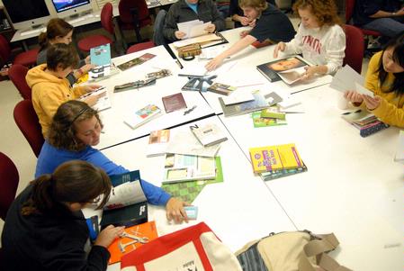 Members of Union's AIGA (American Institute of Graphic Arts) chapter review design samples from a recent graphic design conference. AIGA helps students see professional design and network with designers in the area and around the country.