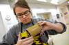 10/15/09 - Paige Ward, senior art major, glazes one of her cups for a ceramics critique. - Kristi McMurry