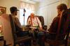 Donald Raines, junior theater major, and Cale Little, freshman undecided major, listen to resident Donald Rains as they volunteer at Alexandria Place Assisted Living on the Day of Remembrance. - Photo by Abby Ott