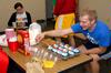 Paul Christensen, freshman youth ministry major, enjoys some snacks during a Life Group meeting with his LG leaders Rachel Donaldson and John Winfree. - Photo by Kristi McMurry