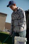 11/4/09 - Joshua David Creswell, junior philosophy major, picks up trash at the Hartland Place apartments during Campus and Community Day. - Beth Spain