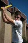 11/4/09 - Jordan Russell, senior business major, removes a stump at the Hartland Place apartments during Campus and Community Day. - Beth Spain