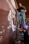 11/4/09 - Colby Stinebaugh (top), sophomore art major, and Angela McDaniel, art department secretary, work diligently on a mural for Daddy's Kitchen Table Soup Kitchen on Campus and Community Day. - Megan Bailey