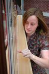 11/9/09 - Anna Wicker, junior music and Spanish major, plays the harp outside of Jennings Hall. - Beth Spain