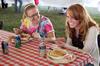 Anna Gilbreth, junior nursing major, and Brooke Walker, senior nursing major, enjoy a time of fellowship over lunch at Arts in the Park for Homecoming 2009. - Photo by Megan Bailey