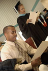 8/3/03 - Germantown Education Specialist graduates Michael Lowe (seated) and Debbie Rudzena go over the program for the August 2003 commencement exercises shortly before the ceremony begins. - Jim Veneman
