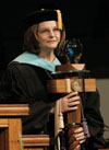 Faculty member of the year Dr. Anne Singleton presents the mace during the August 2003 commencement exercises. - Photo by Jim Veneman