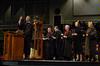 Chris Matthews, music department chair, leads the fall graduation attendees in a chorus of <em>Hark the Herald Angels Sing</em>. - Photo by Sarah Palmer