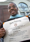 8/3/03 - Graduate Patrick Washington proudly displays his Education Specialist degree in front of West Jackson Baptist Church shortly after the August 2003 commencement exercises. - Jim Veneman
