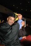 Marshal Brown, physical education and health graduate, switches his tassel from right to left as Ashley Bugg, learning foundations graduate, looks on during fall graduation. - Photo by Beth Spain