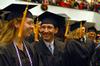 Tara Abernathy and Sam Abraham, nursing graduates, share a laugh as they prepare for fall graduation to begin.  - Photo by Kristi McMurry