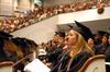 Sarah Elizabeth Montgomery, nursing graduate, listens to the commencement address as she waits to receive her diploma during fall graduation. - Photo by Kristi McMurry