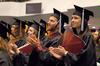 Andrew and Jennifer Boom, education graduates, clap in celebration at fall graduation.  - Photo by Kristi McMurry