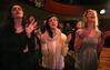 Kari Beogher, junior social work major, Ellen Reinhard, junior public relations major, and Stacy Hanburry, freshman social work major, sing songs of praise at the service commemorating the two-year anniversary of the tornado that hit campus Feb. 5, 2008. - Photo by Angela Abbamonte