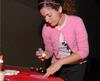 Kayla McKinney, senior learning foundations major, makes a Valentine's Day card for a friend at the Mugs 'N Kisses event hosted by Residence Life. - Photo by Kristi McMurry