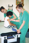 Nursing students Kari Noblett and Amy Rennie provide basic physicals and treat minor illnesses for children at Orphanage Emmanuel while serving on the GO Hondurus team. - Photo by Uncredited