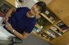 Juanita Cotner poses in her office where she serves as a print graphics technician for College Services.  - Photo by Jonathan Blair