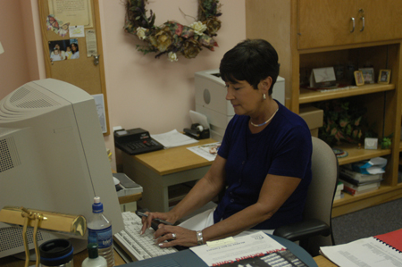 Staff Member of the Year Juanita Cotner works dilligently at her workstation where she provides desktop publishing services for the university.