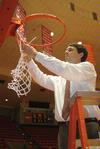Mark Campbell, head coach, cuts a piece of the net after the Lady Bulldogs defeated Azusa Pacific University to become NAIA Division I National Champions. - Photo by Morris Abernathy