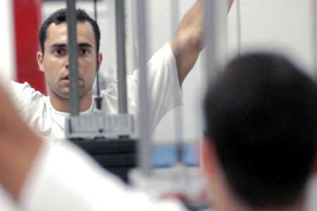 Fabio Buarque of Belo Horizontg, Brazil concentrates as he works out in the Wellness Center.