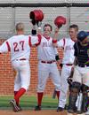 Corey Rudolph (27), Grant Luke (middle) and Beau Baker (right) celebrate a Rudolph home run. - Photo by Steven Aldridge