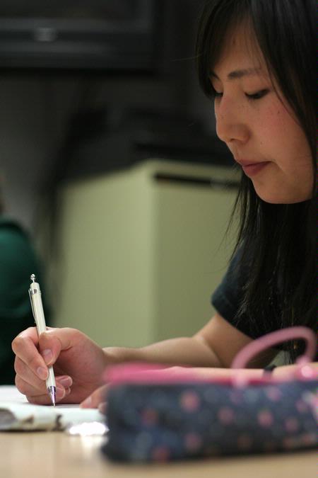 Shinae Giffin, sophomore art major, works on a drawing for a student-curated art show in Barefoots Joe. 