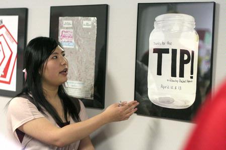 Shinae Giffin, sophomore art major, presents her poster for the student film "Thanks for the Tip" for her Graphic Design II class. 