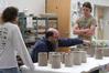 Lee Benson, professor of art and department chair, does a critique of Kelsey Nagy's and Zac Benson's ceramics.   - Photo by Kristi McMurry
