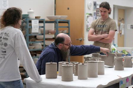Lee Benson, professor of art and department chair, does a critique of Kelsey Nagy's and Zac Benson's ceramics.  