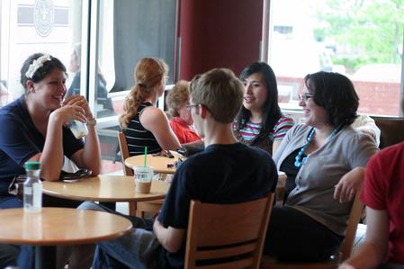Mallory Carter, senior business administration major, AJ Shelby, sophomore digital media studies major, and Shinae Giffin, sophomore art major, enjoy coffee with their graphic design professor, Melinda Eckley, after researching package design in Wal-Mart. 