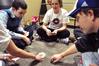 Peter Holmes, Jill Frank, Will Paul and others play cards at their weekly game night in the Bowld Commons. - Photo by Ryan Oetting