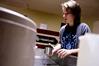 Emma Robertson, junior music education major, develops her photography project in the Photo House.  - Photo by Ryan Oetting
