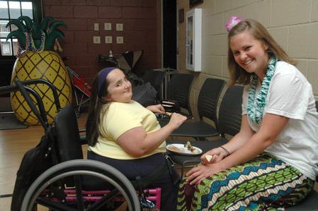 Cheryl Propst and Elizabeth Shaw share some Hawaiian themed snacks at  the Luau sponsored by Residence Life.