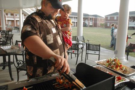 Tim Vancleave and his daughter Carly prepare shish-kabobbs for the Residence Life Luau.