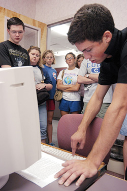 8/26/2003 - John Reed explains to his FOCUS group how to login to the campus network in the computer center. (ID: 1394)