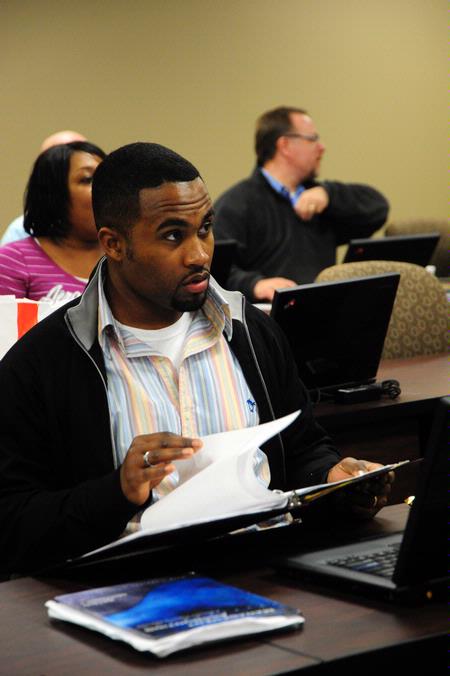 Students listen intently in a BSOL Degree Program class. 