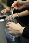 Students conduct a chemistry experiment in lab. - Photo by Morris Abernathy