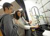 Dr. Sally Henrie, professor of chemistry, helps a student with a lab experiment.  - Photo by Morris Abernathy