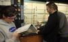 Students conduct a chemistry experiment in lab. - Photo by Morris Abernathy