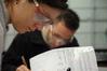 Students take notes after a chemistry experiment in lab. - Photo by Morris Abernathy