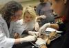 Dr. Jennifer Gruenke, associate professor of biology, helps her students with a dissection in biology lab.  - Photo by Morris Abernathy