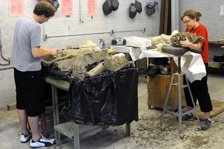 Art majors Colby Stinebaugh and Kelsey Roberts work on sculptures in the art department. 