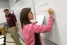 4/26/10 - Dr. Troy Riggs, professor of mathematics, watches as his students write their homework problems on the board before class. - Morris Abernathy