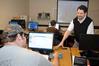 Dr. Jan Wilms, professor of computer science and department chair, helps a student with an assignment. - Photo by Morris Abernathy