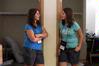 Caroline and Jill Miller, twin sisters and incoming freshmen, chat outside of their dorm rooms after getting their boxes moved in.  - Photo by Kristi McMurry
