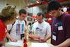 Tyler and Seth Jeffers, incoming freshmen, along with their father Jeff, fill out papers for New Student Move In Day.  - Photo by Abigail Harris