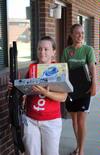 Kathryn LaMar and Rachel Jacks help new students carry things into the dorms on Move In Day. - Photo by Victoria Stargel