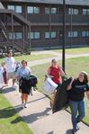 Fonsie Guilaran (far left), associate professor of physics, joins other faculty, staff, and students in helping new students move in for the fall semester.  - Photo by Victoria Stargel