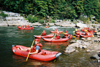 Kevin McDaniel and his fellow funyakers take a breather as a few rafters surf on a rapid on the Upper Nolichucky River. - Photo by Cam Tracy