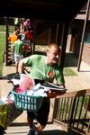 Life Group Leader, John Winfree, carries things upstairs in the Heritage Complex for a new student on Move In Day. - Photo by Ebbie Davis